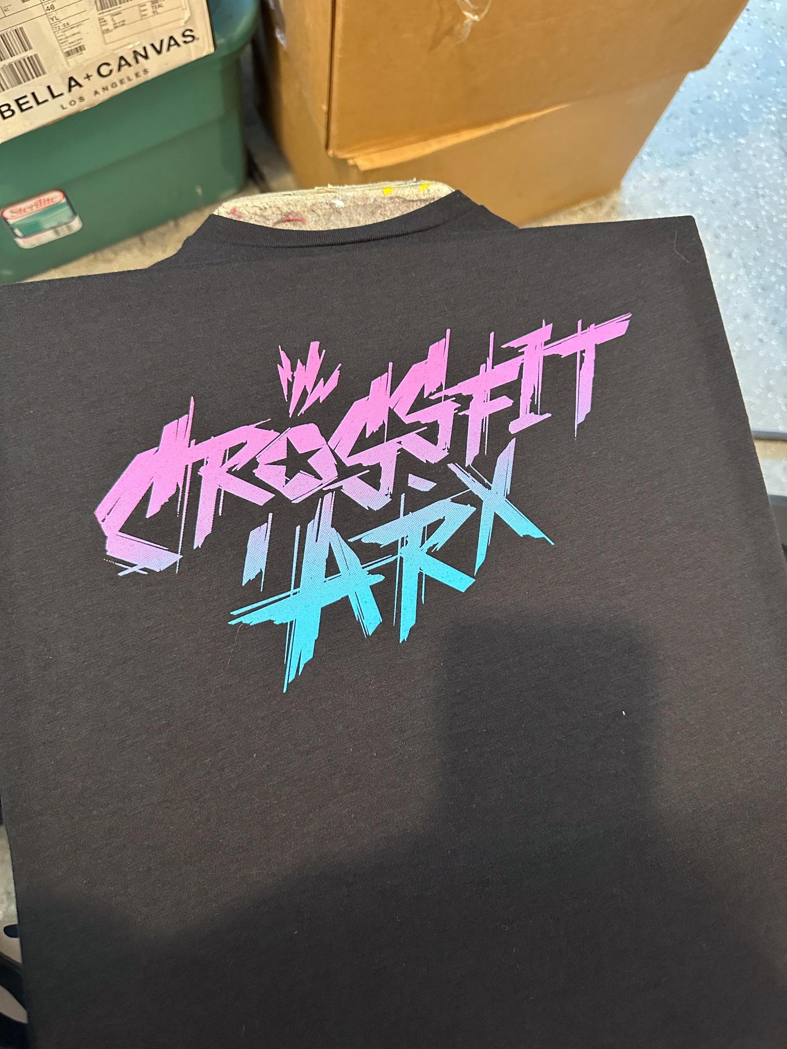 CrossFit ARX artwork printed in pink and blue on a black shirt