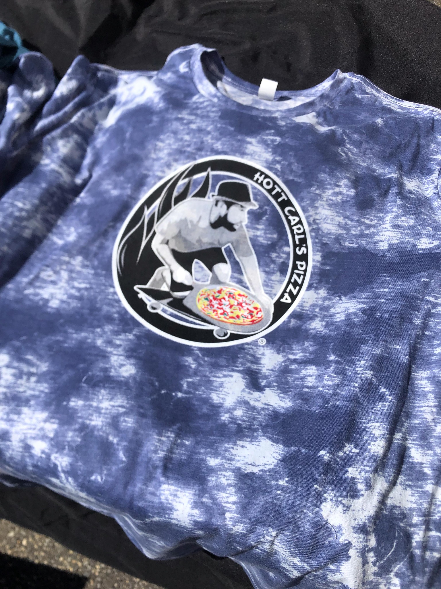 Hott Carl’s Pizza graphic printed on a blue and white tie-dye shirt
