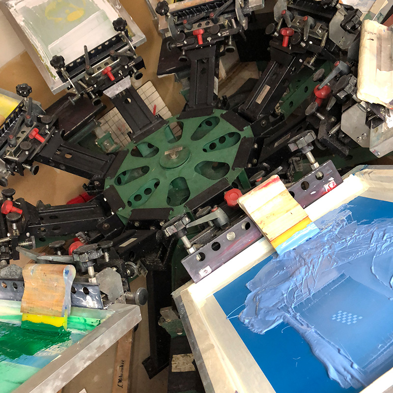 Atlas screen-printing press with blue and green ink on the screens
