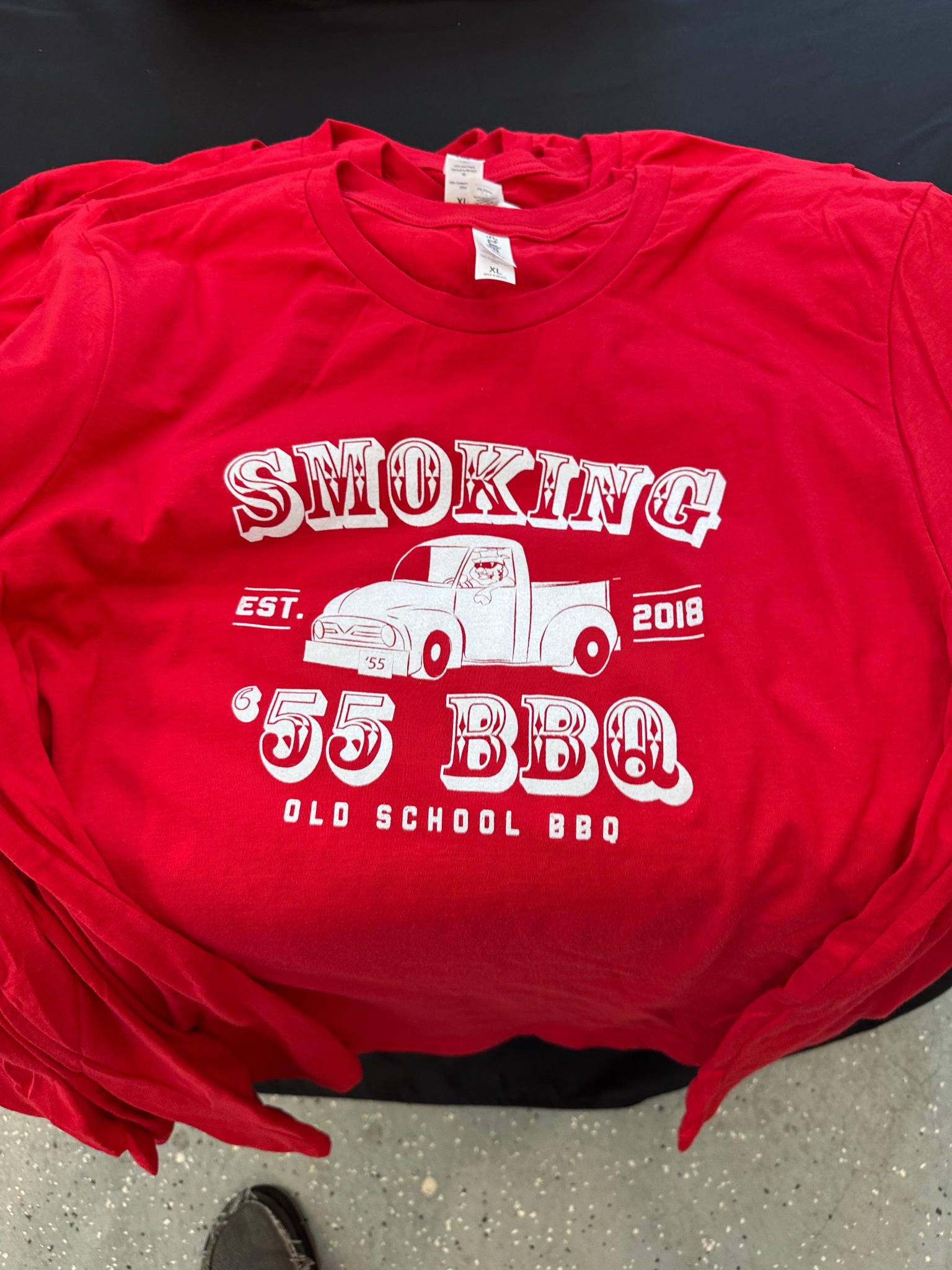 Red Smoking ’55 BBQ shirts with a white truck and lettering design